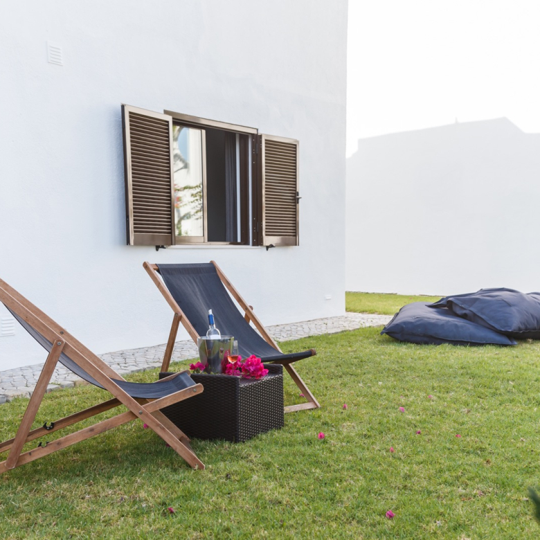 summer apartment garden with chairs and pillows setup