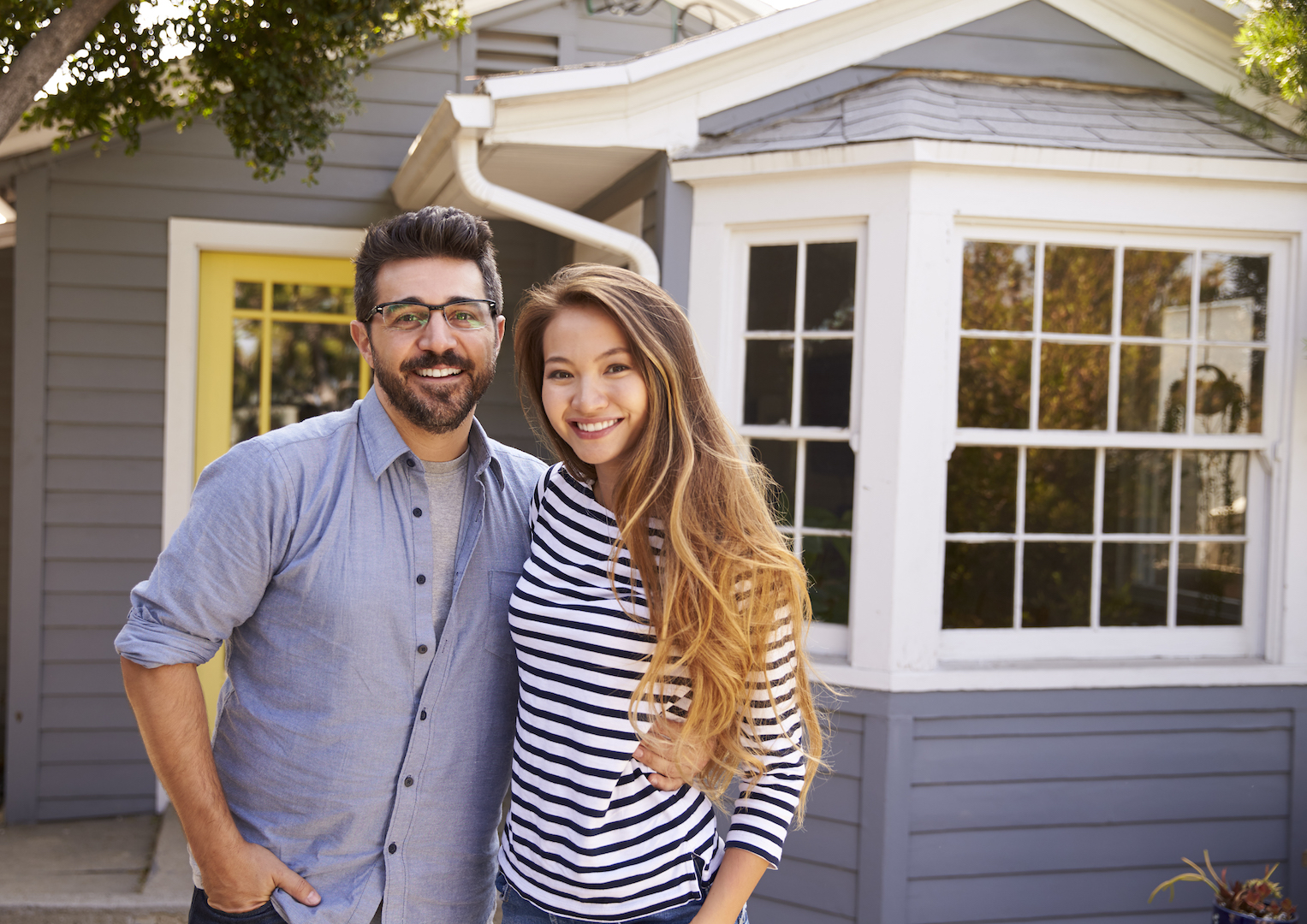 portrait of excited couple standing outside new pem5g4h1.jpg